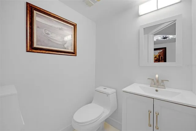 a white toilet sitting next to a bathroom sink