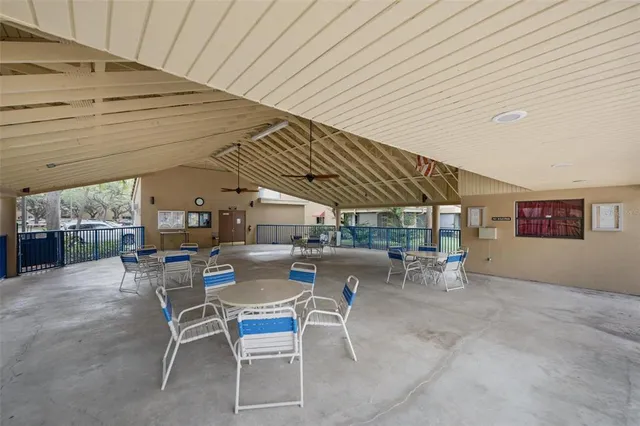 a view of a patio with table and chairs under an umbrella