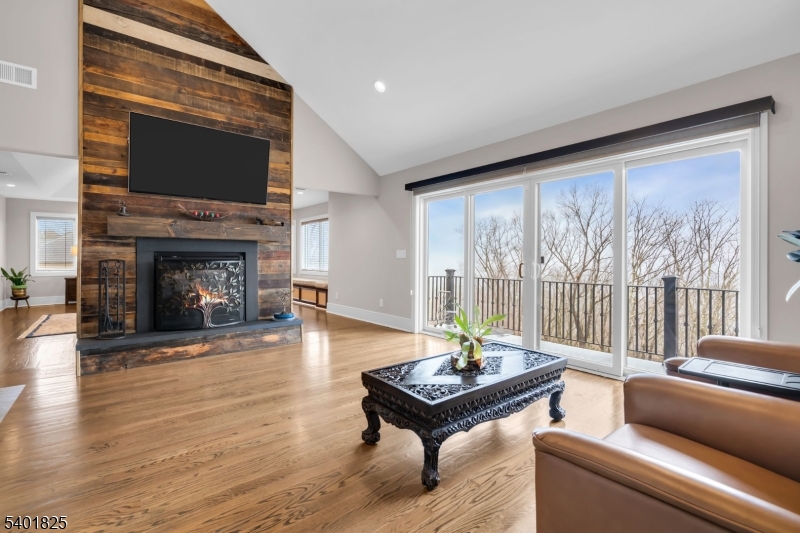 846 Sunset Ridge Bridgewater, NJ 08807 - Photo 25 of 50 a living room with furniture a fireplace and a floor to ceiling window
