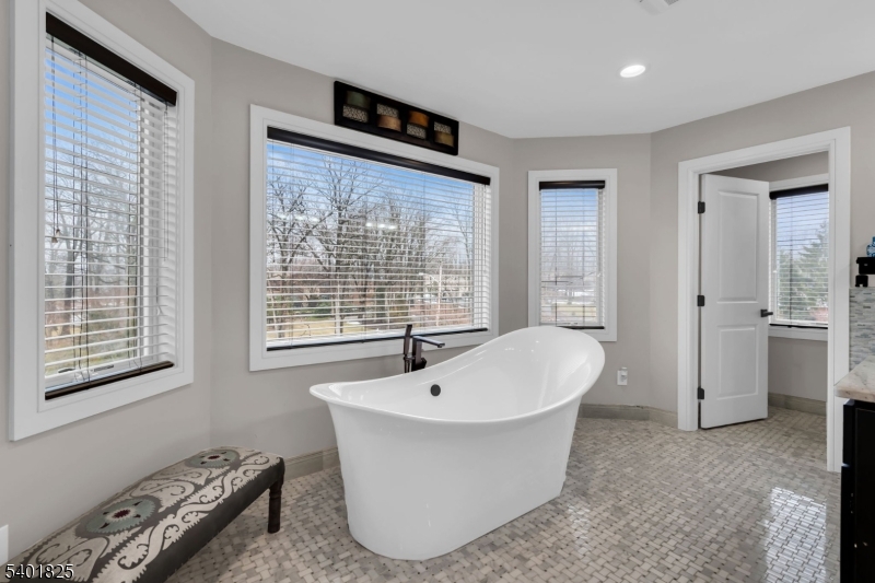 846 Sunset Ridge Bridgewater, NJ 08807 - Photo 29 of 50 a white bath tub sitting in a bathroom next to a window