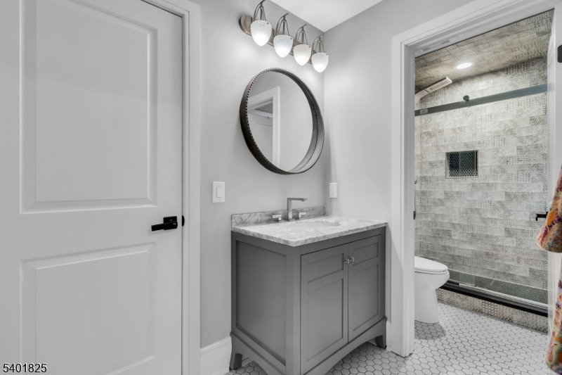 846 Sunset Ridge Bridgewater, NJ 08807 - Photo 33 of 50 a bathroom with a granite countertop sink a toilet and a mirror