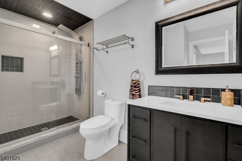 846 Sunset Ridge Bridgewater, NJ 08807 - Photo 37 of 50 a bathroom with a sink a toilet a mirror and shower