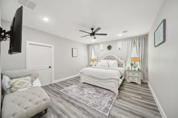 a bedroom with a large bed and a window