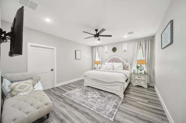 a bedroom with a large bed and a window