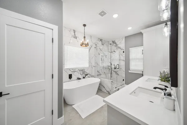 a spacious bathroom with a sink mirror and a bathtub