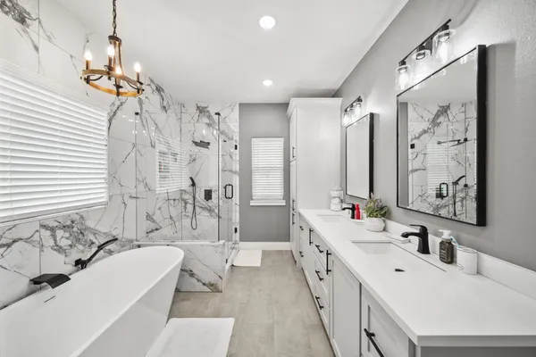 a bathroom with a double vanity sink mirror double and shower