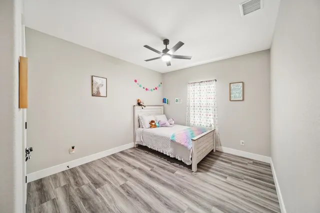 a room with a bed and a chandelier