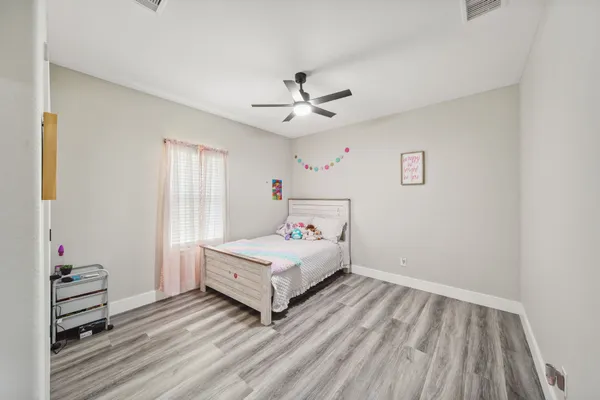 a room with a bed and a chandelier