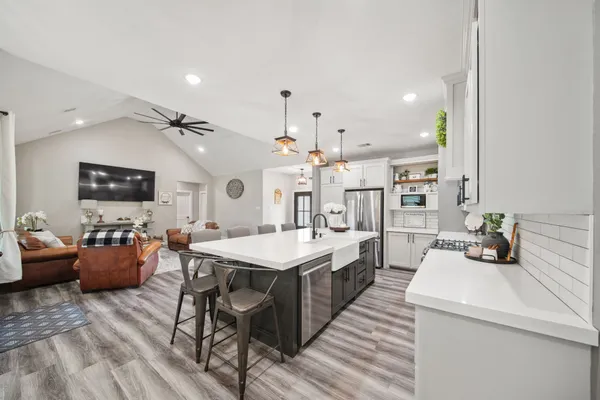a large kitchen with a table and chairs