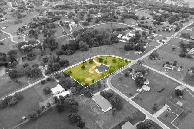 an aerial view of a house with a swimming pool