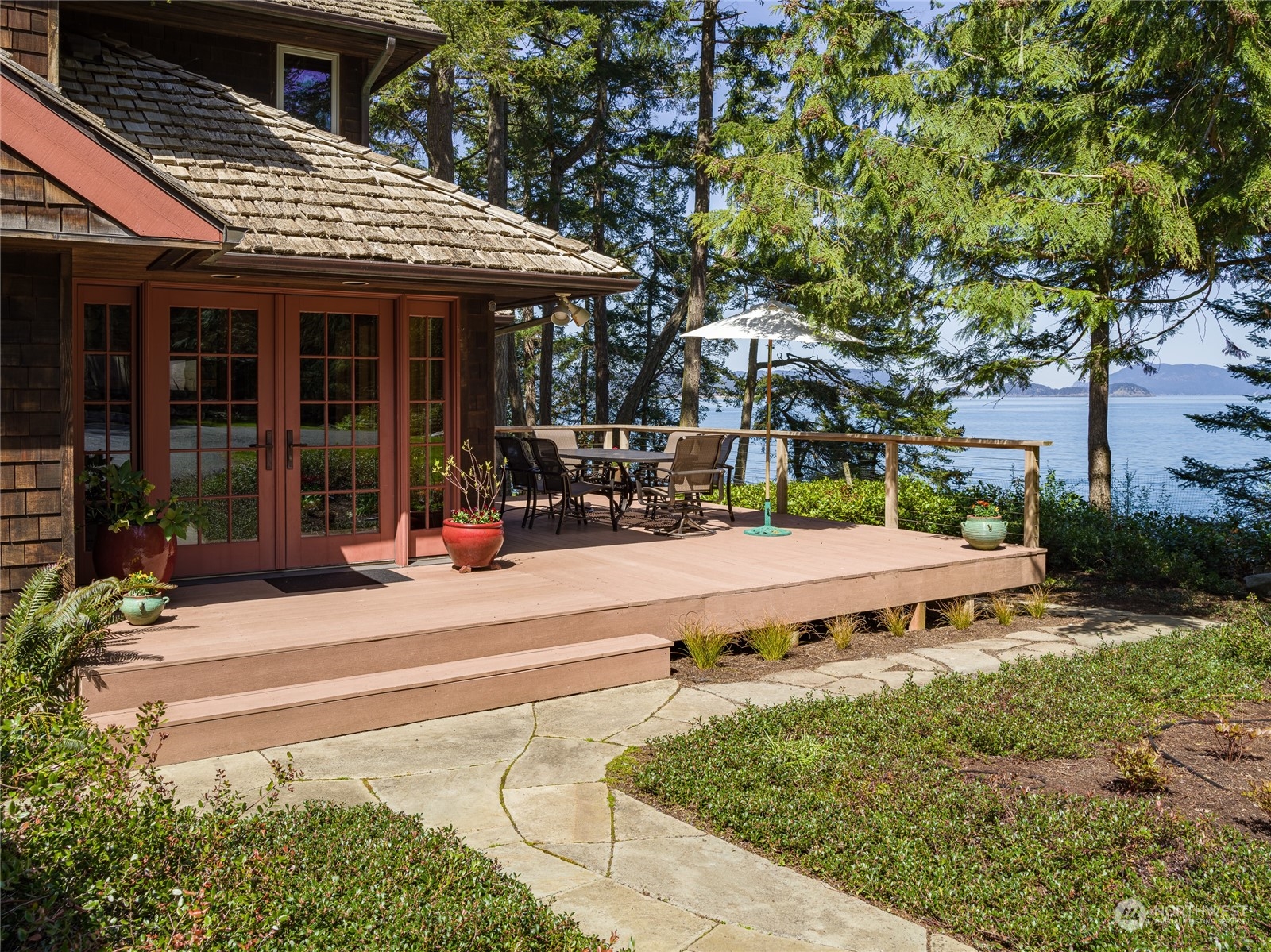 777 Eliza Road Lopez Island, WA 98261 - Photo 2 of 38 a view of a house with a large tree and plants