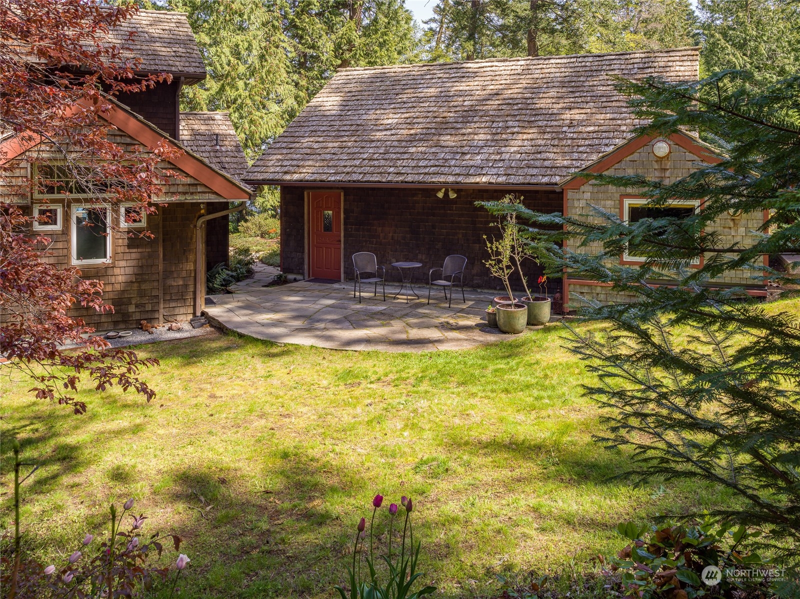 777 Eliza Road Lopez Island, WA 98261 - Photo 28 of 38 a view of a patio with table and chairs under an umbrella