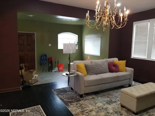 a living room with furniture and a chandelier