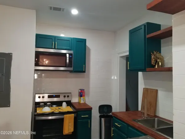 a kitchen with a stove and a microwave