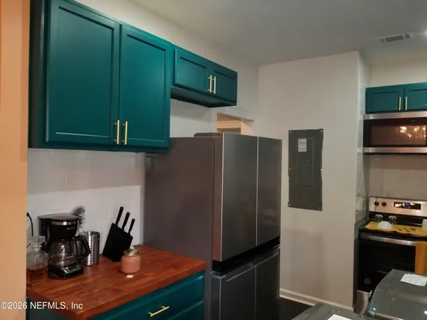 a kitchen with a refrigerator and cabinets
