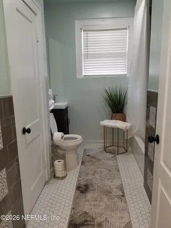 a bedroom with bed and window