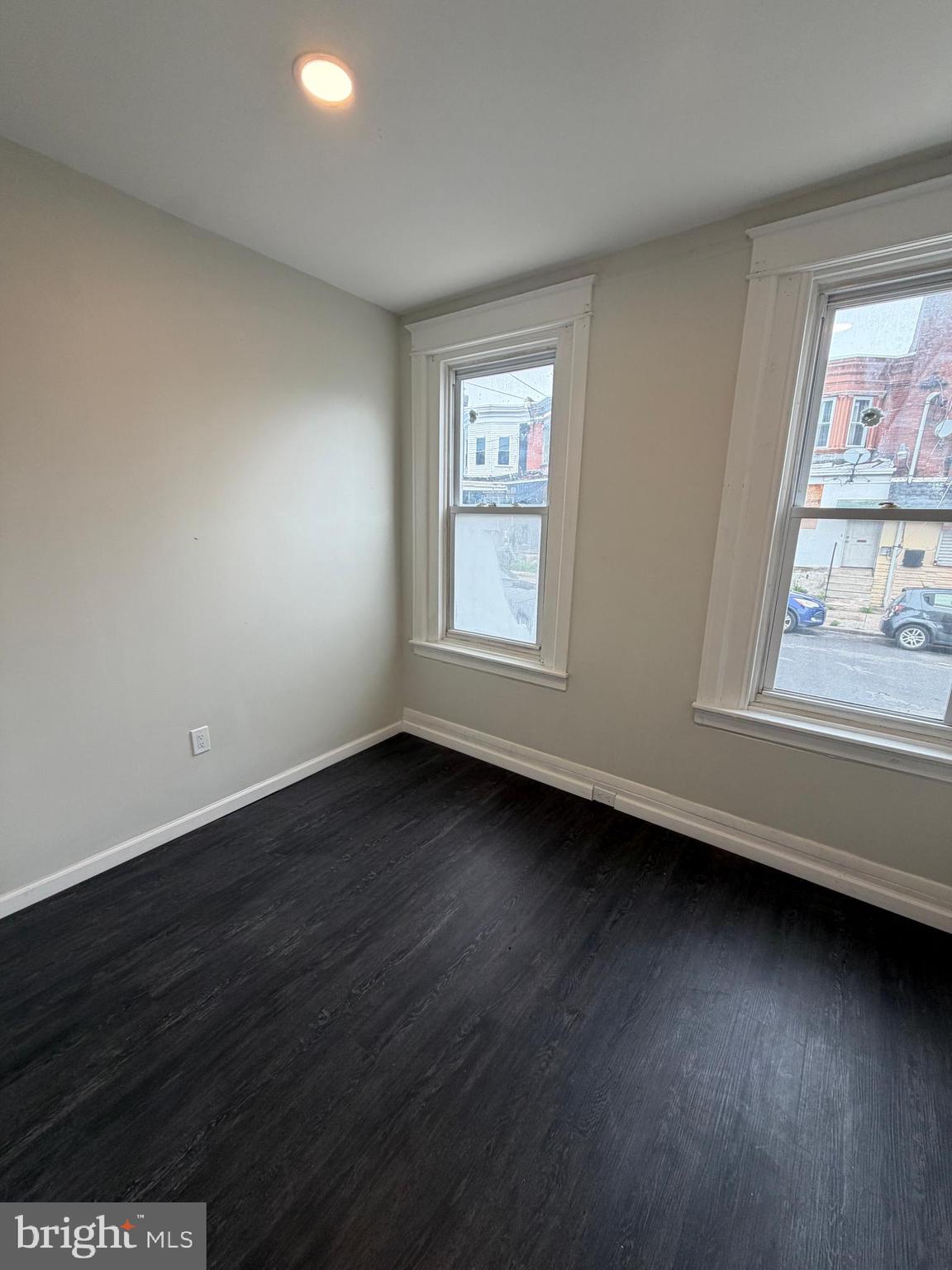3760 North 9th Street Philadelphia, PA 19140 - Photo 17 of 17 a view of an empty room with wooden floor and a window