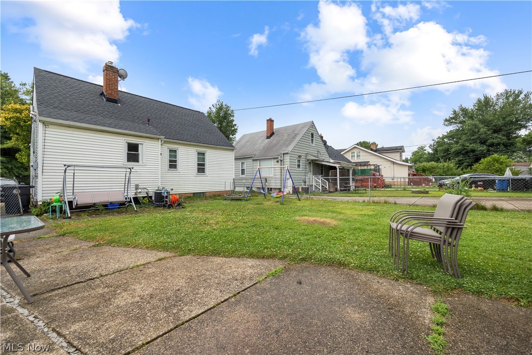 18318 Homeway Road Cleveland, OH 44135 - Photo 5 of 30 Expansive backyard with a concrete patio and a lush green lawn