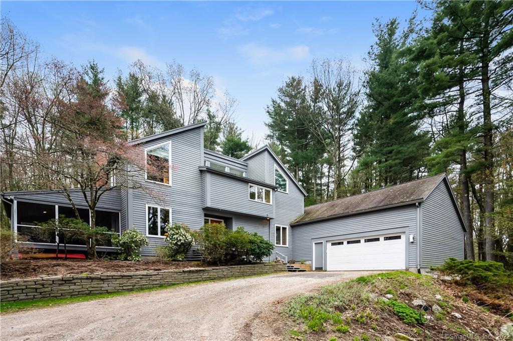 17 Pinnacle Mountain Road Simsbury, CT 06070 - Photo 1 of 1 a front view of a house with a yard