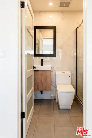 a bathroom with a sink toilet and mirror