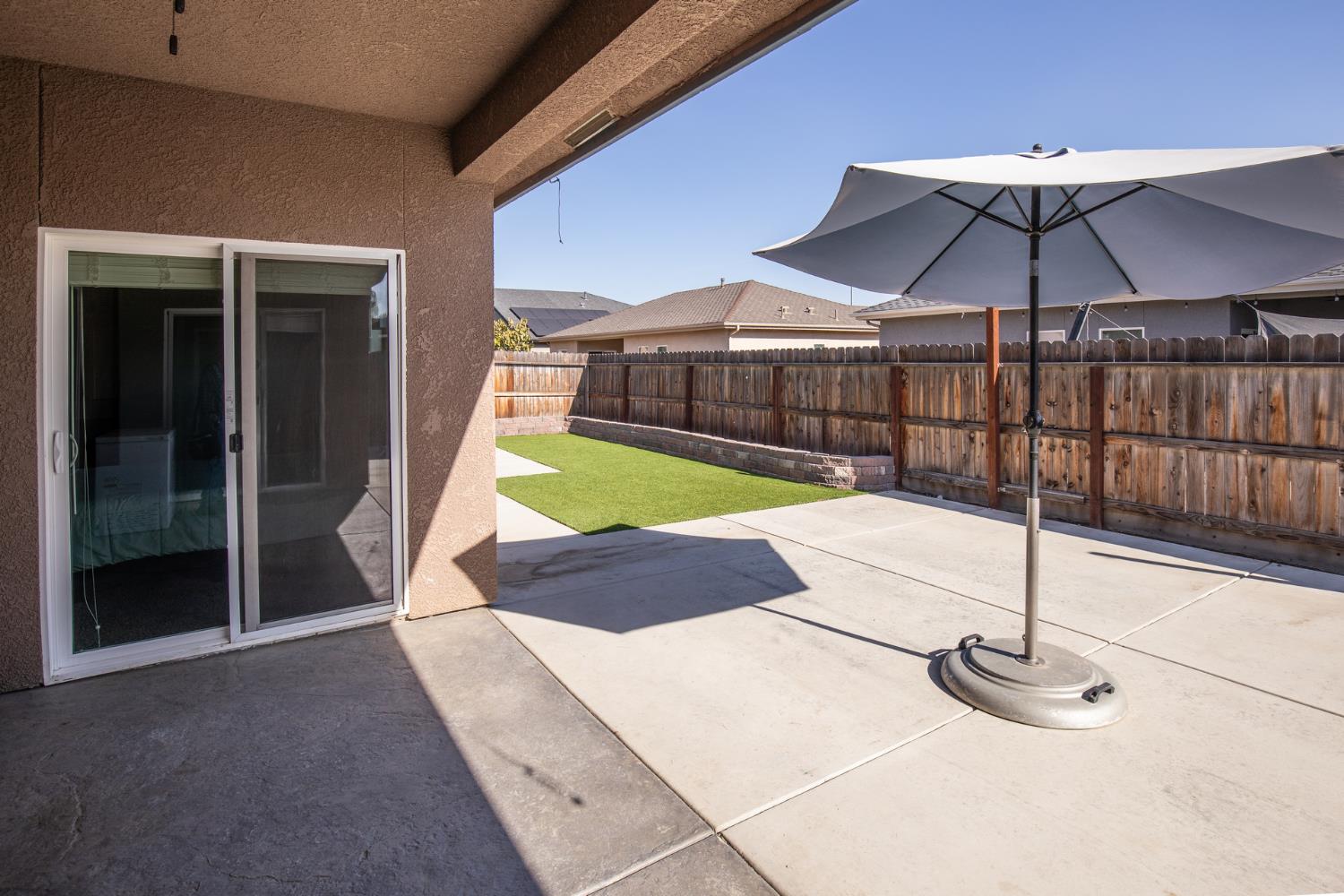 1374 South Enns Avenue Reedley, CA 93654 - Photo 31 of 48 a view of a backyard with a small cabin