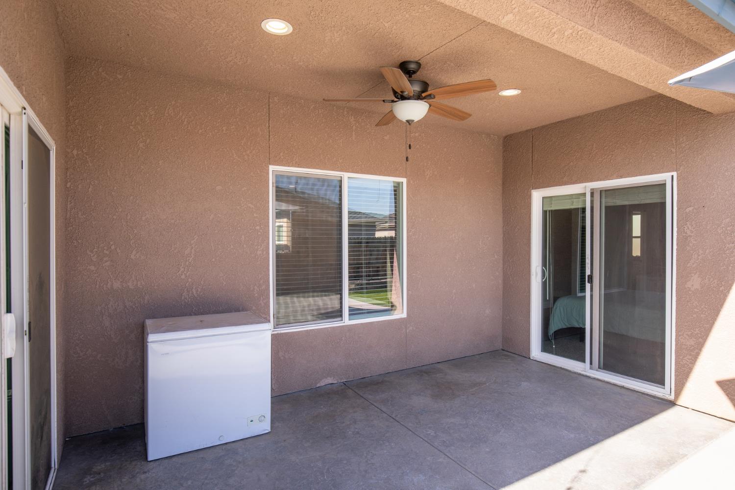 1374 South Enns Avenue Reedley, CA 93654 - Photo 43 of 48 a view of an empty room with window and chandelier fan