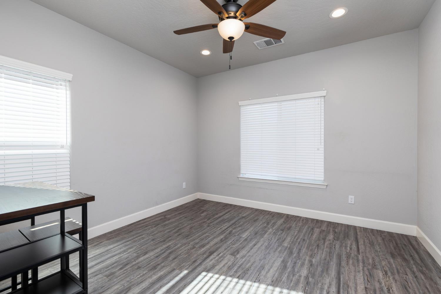 1374 South Enns Avenue Reedley, CA 93654 - Photo 45 of 48 a view of an empty room with wooden floor and a window