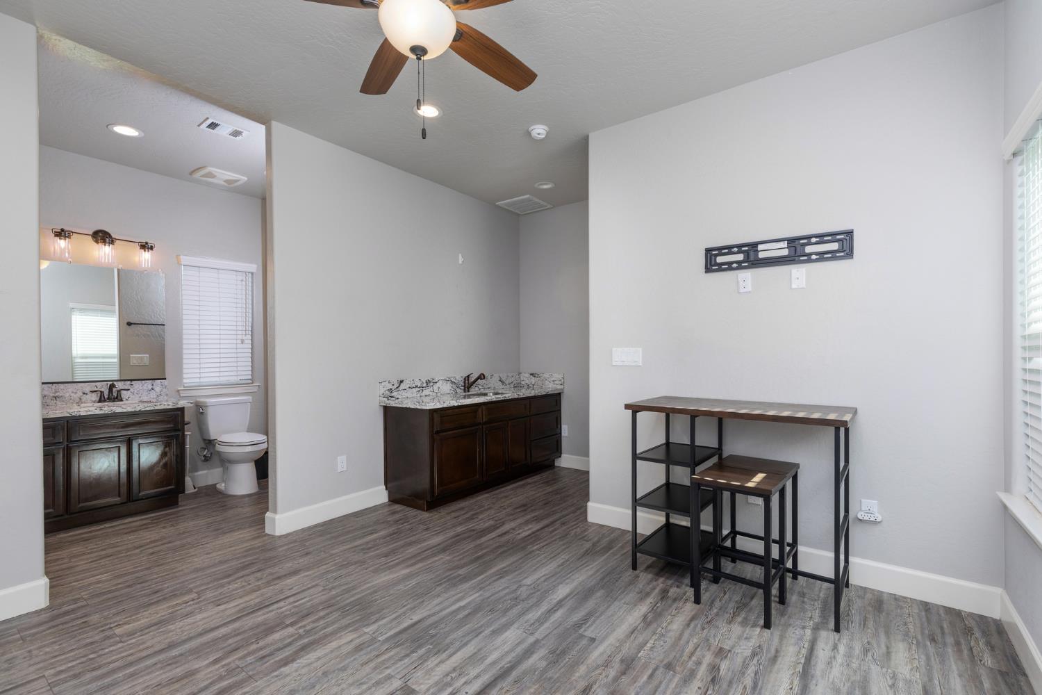 1374 South Enns Avenue Reedley, CA 93654 - Photo 47 of 48 a view of a workspace with furniture and wooden floor