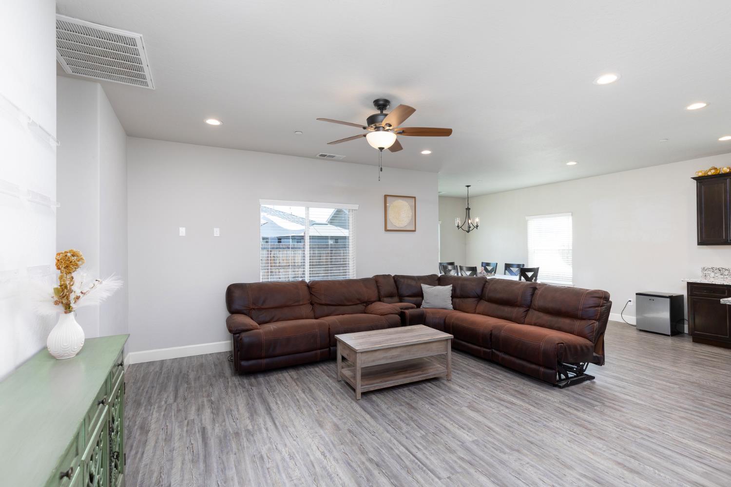 1374 South Enns Avenue Reedley, CA 93654 - Photo 6 of 48 a living room with furniture and a wooden floor