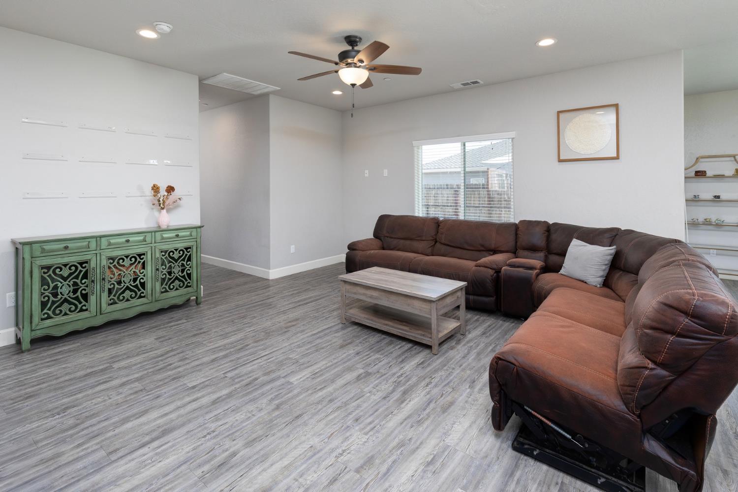 1374 South Enns Avenue Reedley, CA 93654 - Photo 9 of 48 a living room with furniture and a wooden floor