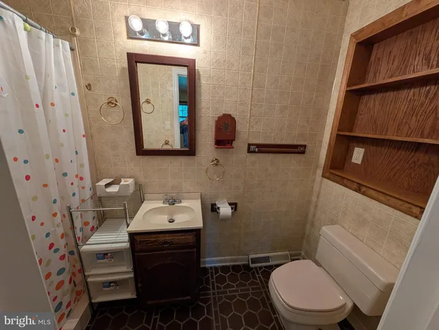 a bathroom with a sink toilet and mirror