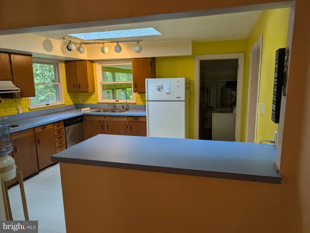 a kitchen with a refrigerator and a table