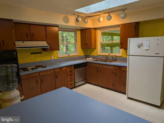 a kitchen with a sink a stove and refrigerator