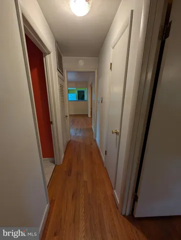a view of a hallway with wooden floor