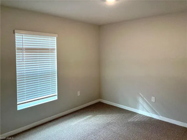 a close view of a stove and a refrigerator in a kitchen