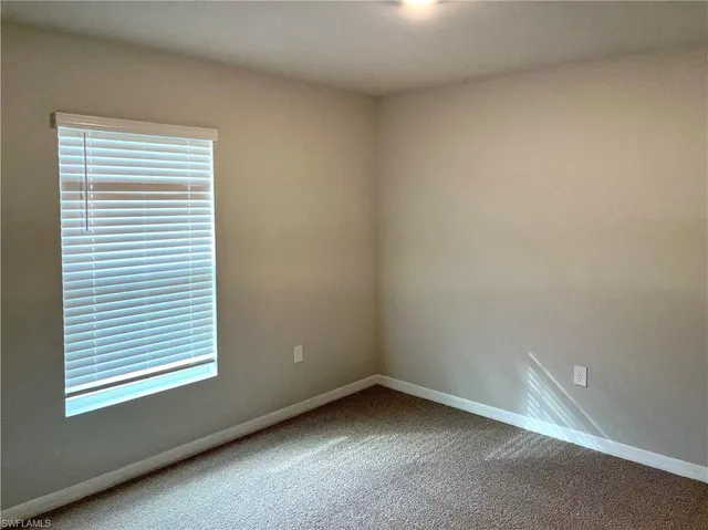 a close view of a stove and a refrigerator in a kitchen