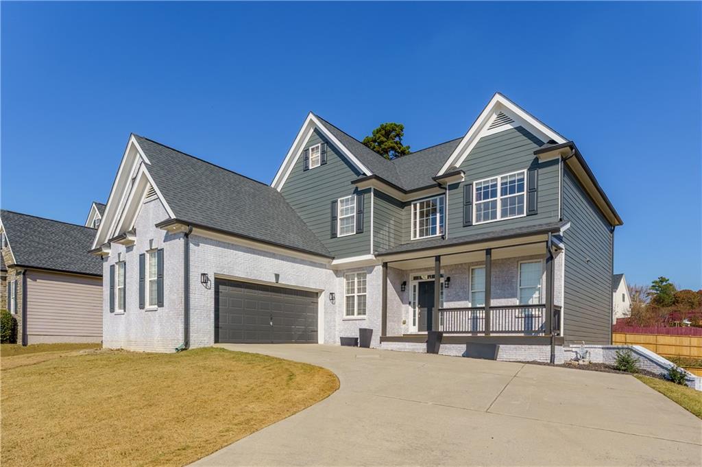 976 Redstone Road Dacula, GA 30019 - Photo 1 of 43 a front view of a house with a yard