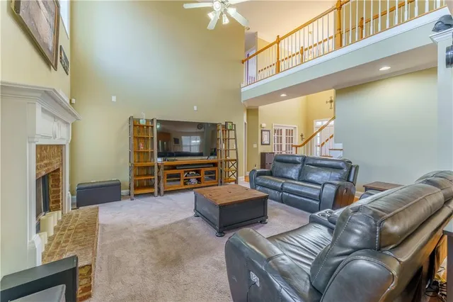 a kitchen with a sink a stove a refrigerator cabinets and a window