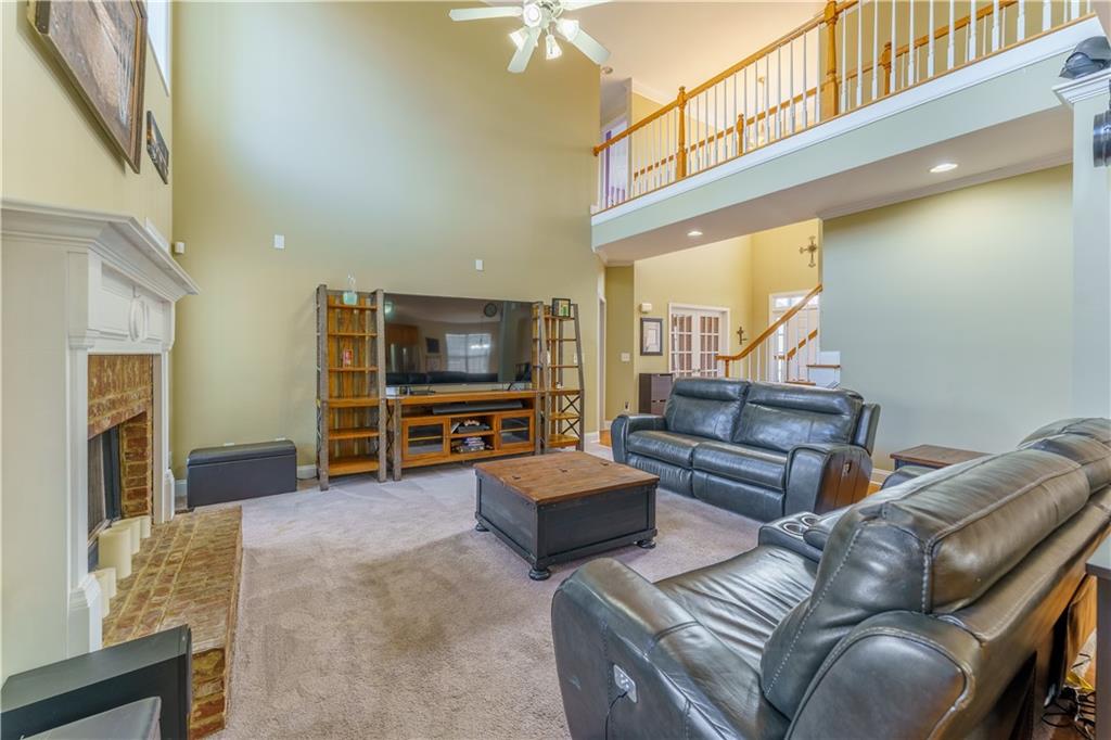 976 Redstone Road Dacula, GA 30019 - Photo 13 of 43 a living room with furniture and a flat screen tv