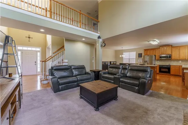 a large kitchen with stainless steel appliances granite countertop a sink a window and a refrigerator