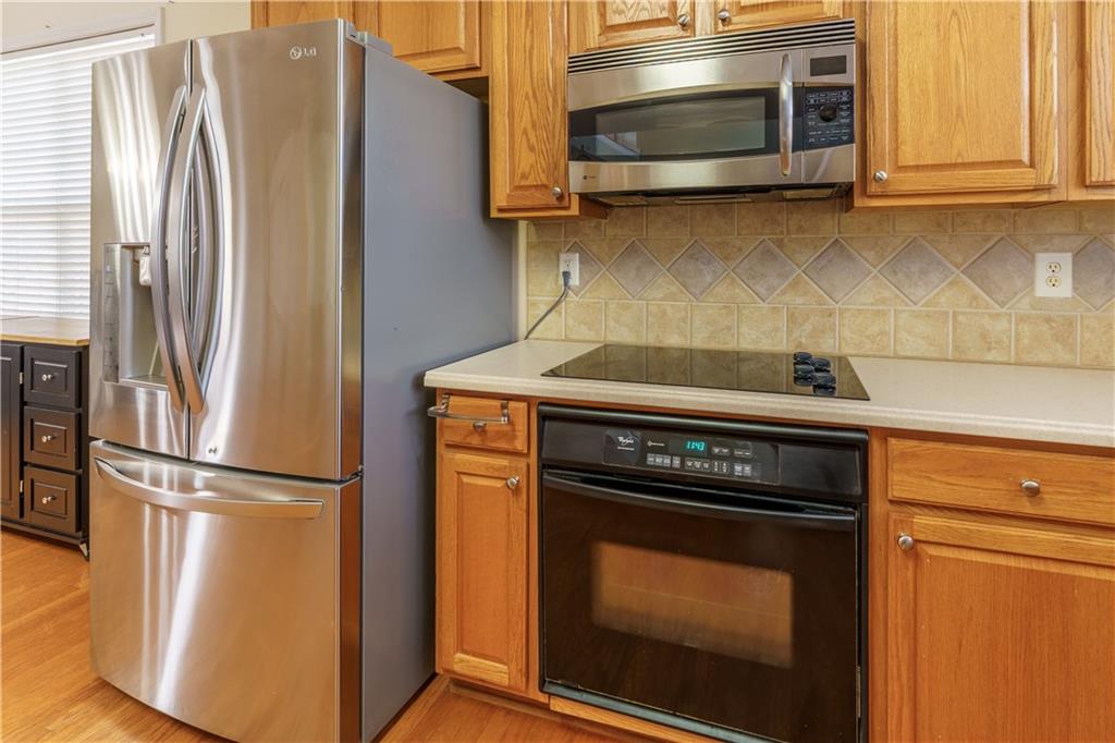976 Redstone Road Dacula, GA 30019 - Photo 19 of 43 a kitchen with a stove and a microwave