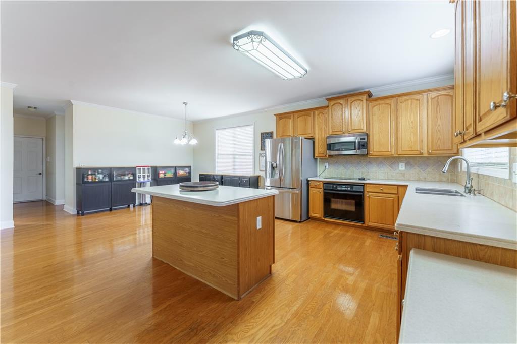 976 Redstone Road Dacula, GA 30019 - Photo 20 of 43 a kitchen with stainless steel appliances granite countertop a sink a stove top oven a counter space and cabinets