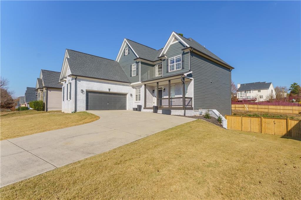 976 Redstone Road Dacula, GA 30019 - Photo 2 of 43 a front view of a house with a yard