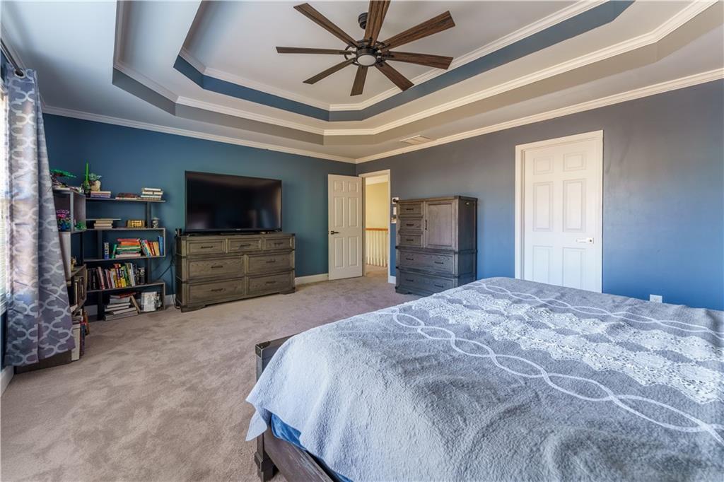 976 Redstone Road Dacula, GA 30019 - Photo 28 of 43 a spacious bedroom with a bed and a flat screen tv