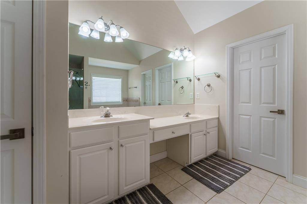 976 Redstone Road Dacula, GA 30019 - Photo 30 of 43 a spacious bathroom with a double vanity sink a mirror and a shower