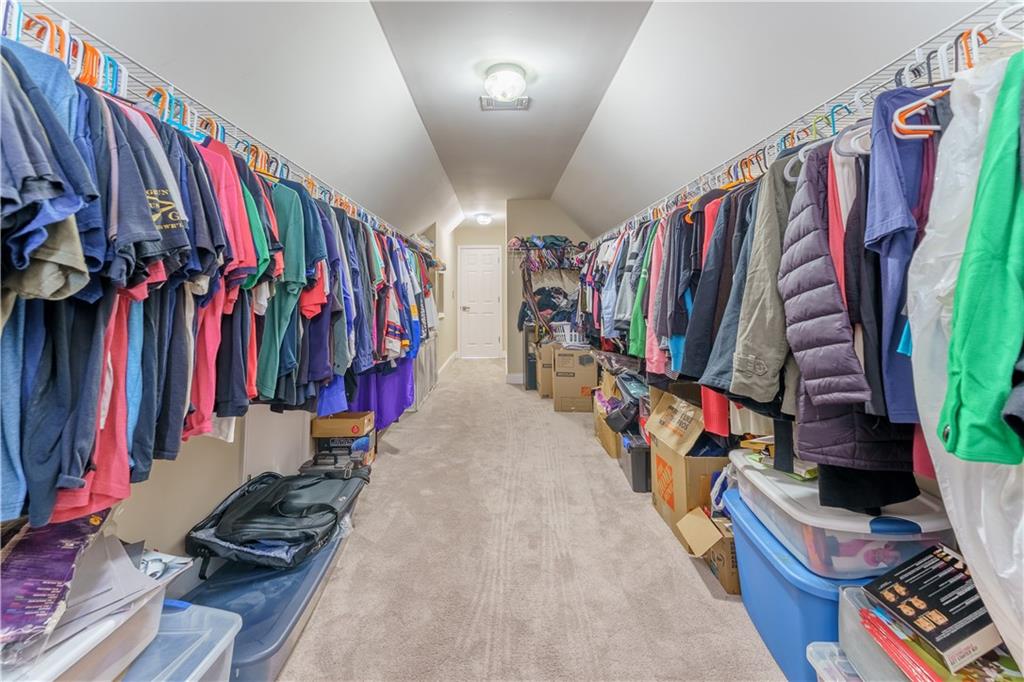 976 Redstone Road Dacula, GA 30019 - Photo 34 of 43 a view of walk in closet with clothes