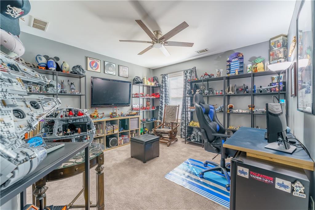 976 Redstone Road Dacula, GA 30019 - Photo 35 of 43 a work room with furniture and a flat screen tv