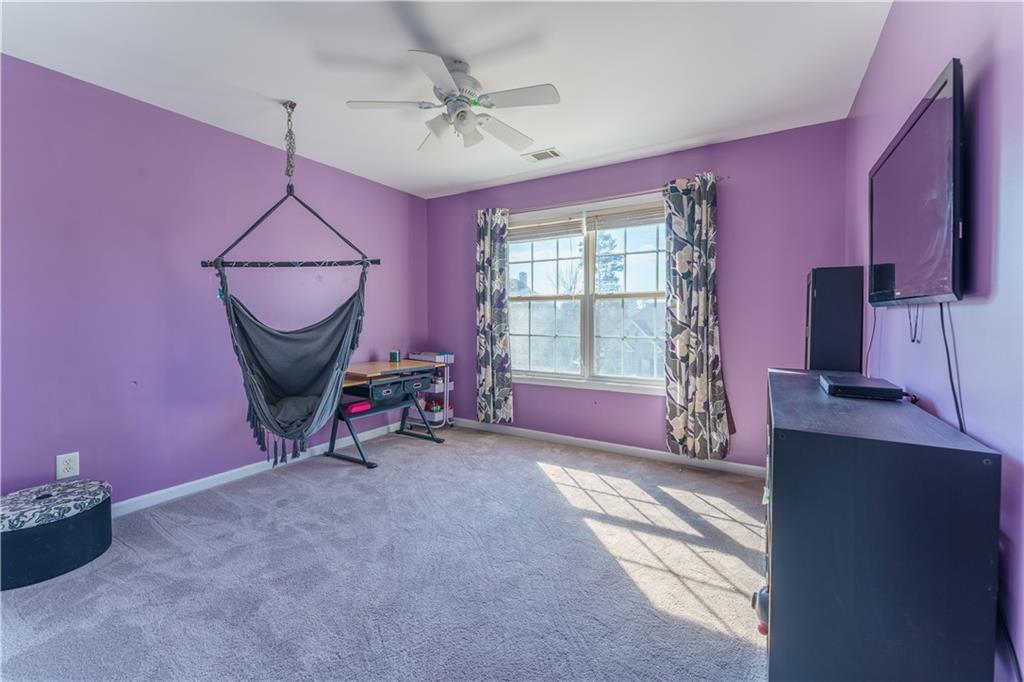 976 Redstone Road Dacula, GA 30019 - Photo 38 of 43 a living room with furniture a flat screen tv and a window