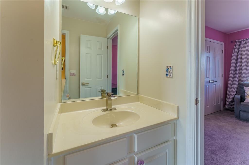 976 Redstone Road Dacula, GA 30019 - Photo 40 of 43 a bathroom with a sink and a mirror
