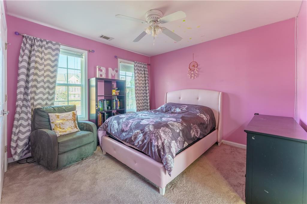 976 Redstone Road Dacula, GA 30019 - Photo 41 of 43 a spacious bedroom with a bed and a couch